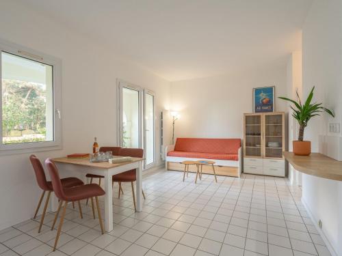 a living room with a table and a couch at Apartment Parc de Pontaillac-31 by Interhome in Vaux-sur-Mer