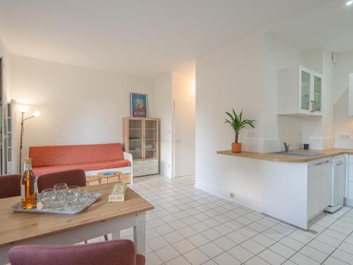 a kitchen and living room with a couch and a table at Apartment Parc de Pontaillac-31 by Interhome in Vaux-sur-Mer
