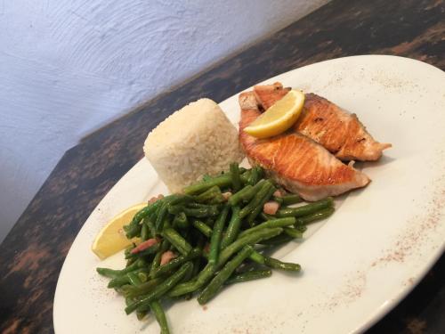 a plate of food with salmon and green beans and bread at Hôtel Le Roi Gourmand in Pamiers