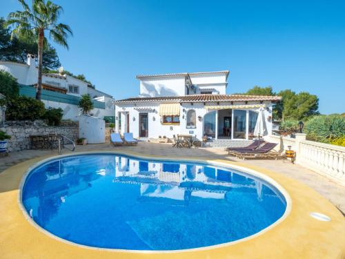 a large swimming pool in front of a house at Villa Moraira Magica by Interhome in Moraira