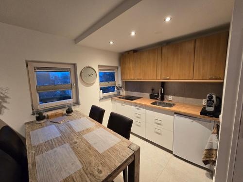 a kitchen with a wooden table and a dining room at Studio Amnesia in Heerhugowaard