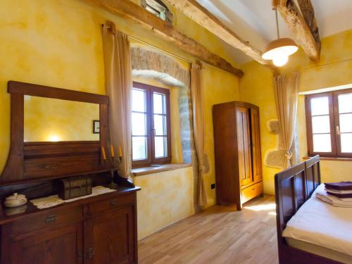 a room with a bedroom with a mirror and a bed at Holiday Home Franz by Interhome in Potpićan