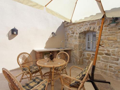 a table and chairs in a room with a fireplace at Holiday Home Franz by Interhome in Potpićan