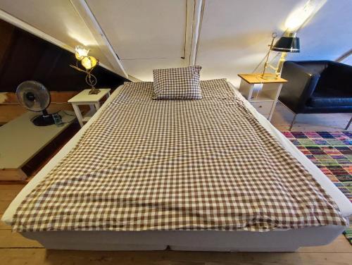 a large bed in a room with a couch at The Garden Hill Hotel in Vallåkra