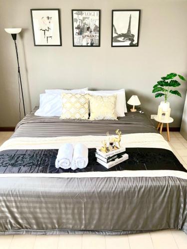 a bedroom with a large bed with two pillows at Impact Arena Condo C1 by GoodRoom24 in Ban Song Hong