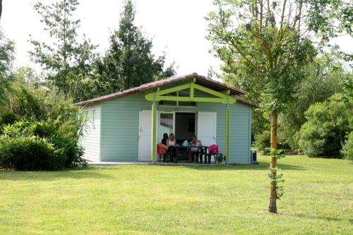 a group of people sitting at a table in a shed at Lagrange Grand Bleu Vacances – Résidence Port Lalande in Castelmoron-sur-Lot