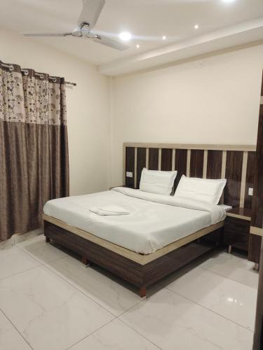 a bedroom with a large bed with white sheets at Hotel G-3 in Jalandhar
