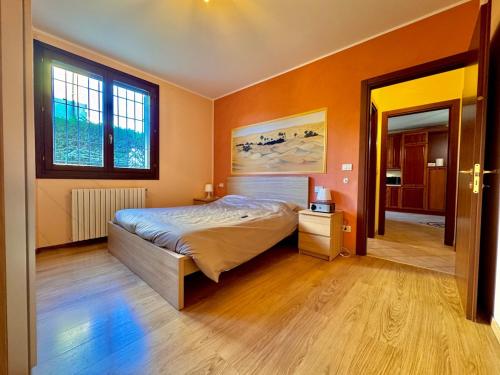 a bedroom with a large bed and a window at Maisonette Rosa dei Venti in Carpi