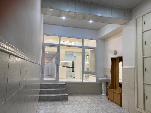 a bathroom with a toilet and a window and stairs at House in Quba in Quba