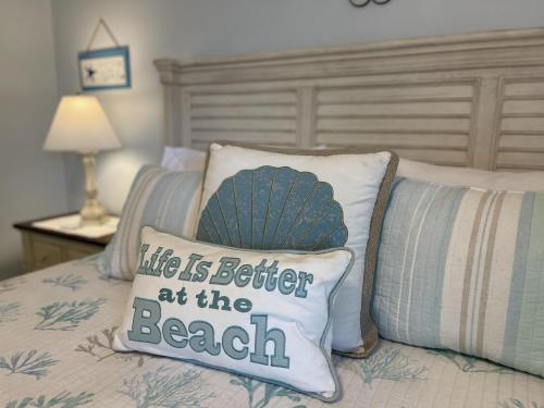 a pillow that says life is better at the beach at Rookery 7026 in Gulf Shores