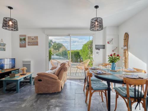 a living room with a table and chairs at Holiday Home Lésaro by Interhome in Saint-Jean-de-la-Rivière
