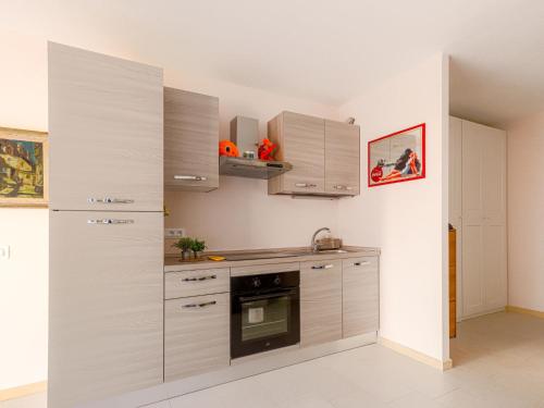 une cuisine avec des armoires blanches et un four dans l'établissement Apartment Le Diplomate by Interhome, à Menton