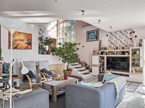 a living room with couches and a tv at Apartment Bonika by Interhome in Fonyód