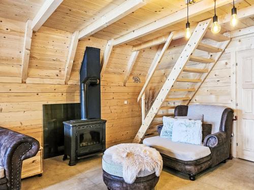 a living room with a fireplace and a stove at Chalet Tomina Koliba Lika by Interhome in Lovinac
