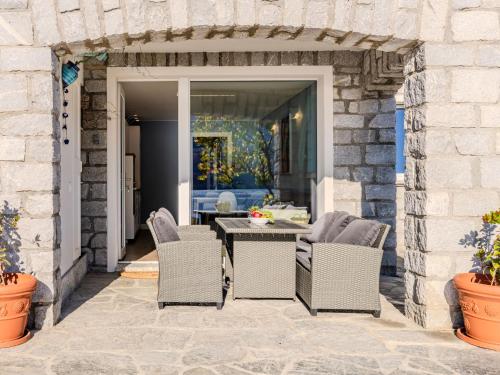 an outdoor patio with a table and chairs at Apartment Lago Infinito by Interhome in Gravedona