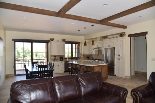 a kitchen with a couch and a table with chairs at New Lodge In The Heart Of Moab, Utah in Moab