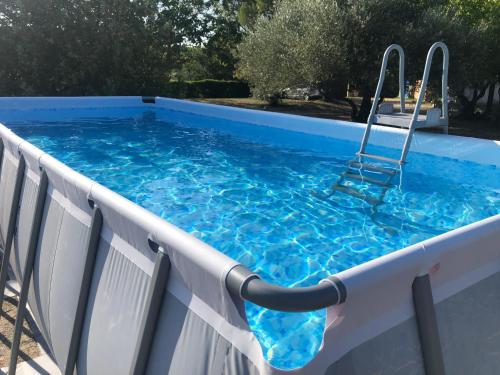 - une piscine avec une chaise dans l'eau dans l'établissement Gîte la Jasse, à Saint-Maurice-de-Cazevieille