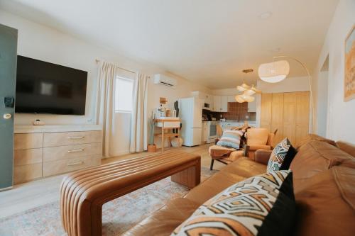 a living room with a couch and a tv at Terracotta Suite at ArnoTriplex! Hot Tub and Pet Friendly! in Albuquerque
