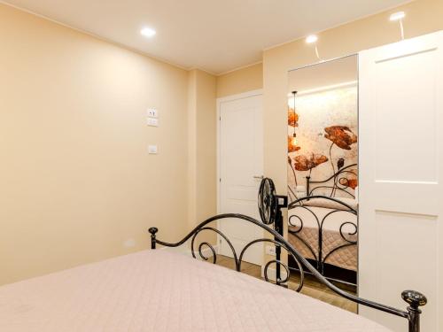 a bedroom with a bed and a mirror at Apartment Riflesso del lago by Interhome in Gravedona