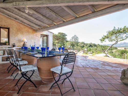 an outdoor dining room with a table and chairs at Villa La Giulia Porto Cervo by Interhome in Arzachena