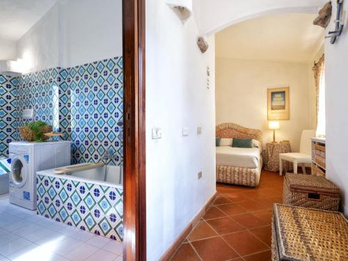 a living room with blue and white tiled walls at Villa La Giulia Porto Cervo by Interhome in Arzachena