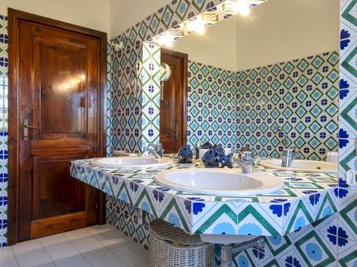 a bathroom with three sinks and a mirror at Villa La Giulia Porto Cervo by Interhome in Arzachena