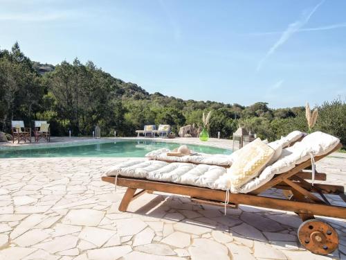 a couple of lounge chairs sitting next to a pool at Villa La Giulia Porto Cervo by Interhome in Arzachena
