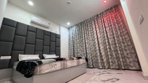 a bedroom with a bed and a large window at Mithila - A Lovely & Peaceful 3 BHK Villa in Orchha