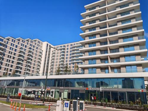 a large building in front of a large building at Planet Lux Apartment in Niš