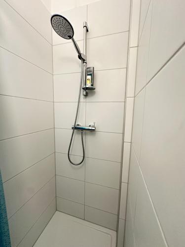 a shower with a shower head in a bathroom at Serenity Apartment - Essential in Leoben