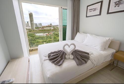 a bedroom with a bed with a heart decoration on it at 芭提雅日瓦达酒店式公寓 in Na Jomtien