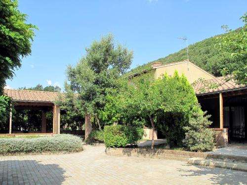 a house with trees and bushes in front of it at Apartment Gufo-31 by Interhome in Podere Dottrina