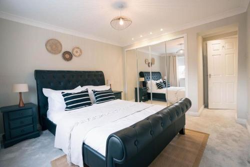 a large bedroom with a large bed and a mirror at St Nicholas Haven in York