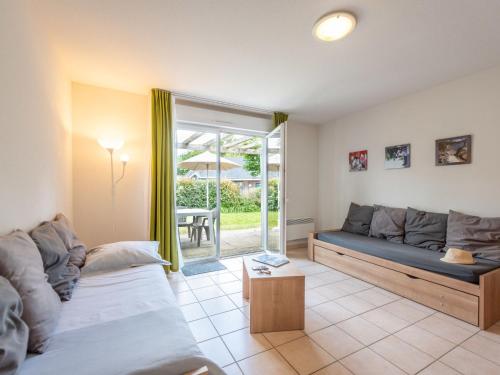 a living room with a couch and a table at Holiday Home Cottage Privilège-1 by Interhome in Saumur