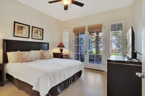 a bedroom with a large bed and a television at Secluded Ground Floor 1BR Villa #A in La Quinta