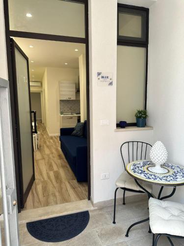 a living room with a table and a couch at Ines Apartments in Giardini Naxos
