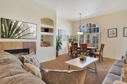 a living room with a couch and a table at Tranquil Ground Floor Villa in Heart of LQ #A in La Quinta