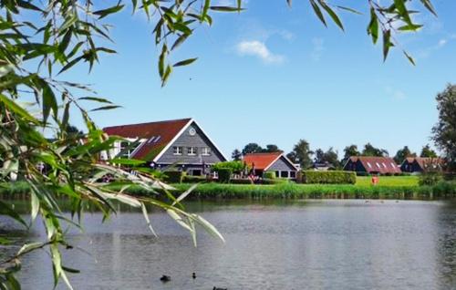 a group of houses next to a body of water at 2 Bedroom Amazing Home In Heinkenszand in Heinkensand