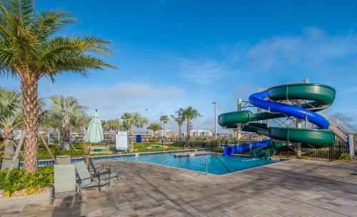a water slide in a resort with a pool at 4809AM TOWNHOUSE 4 BEDROOMS & 3 BATHROOMS + POOL in Kissimmee