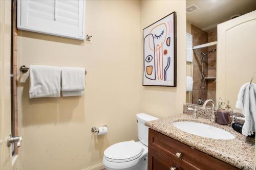 a bathroom with a white toilet and a sink at Picturesque 1BR in Legacy Villas near Main Pool #A in La Quinta