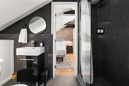 a bathroom with a white sink and a mirror at The Ontario Loft Suites in Montréal