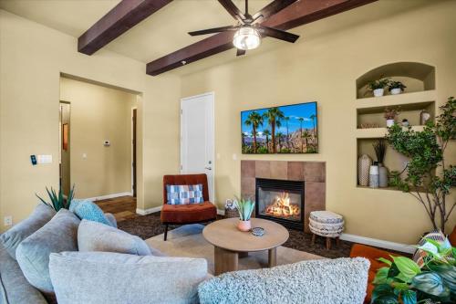 a living room with a couch and a fireplace at Legacy Villas Hideaway overlooking Main Pool #A in La Quinta