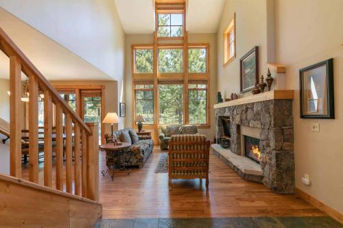a large living room with a stone fireplace at Fairway Drive 13151 by East West Hospitality in Truckee