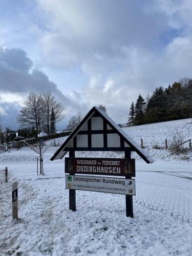 a sign in the snow next to a road at Waldhof Hochsauerland in Medebach
