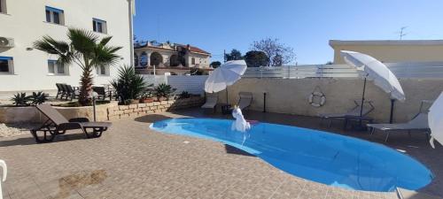 a swimming pool with a bird in the water at Pool Seaside Relais - VILLE Ninfea, Marea, Rosa e Cassiopea in Fontane Bianche