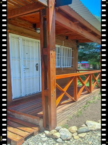 a large wooden deck with a white door at Cabaña en las Sierras, Sierras Rio Sol!!! Espectacular Cabaña Frente al Rio y las Sierras in Santa María