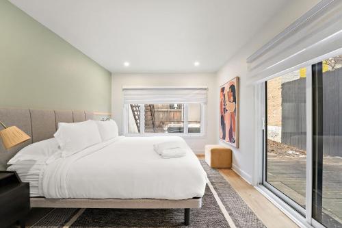 a bedroom with a white bed and a window at The Ontario Loft Suites in Montréal