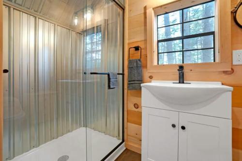 a bathroom with a sink and a shower at A-Frame Retreat with Inviting Hot Tub in Oxford