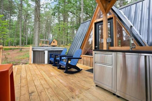 a large kitchen and living area of a tiny house at A-Frame Retreat with Inviting Hot Tub in Oxford
