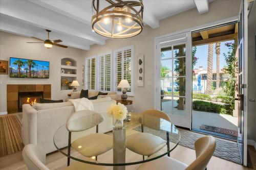 a living room with a couch and a table at Modern LQ Getaway Steps to pool & spa #A in La Quinta